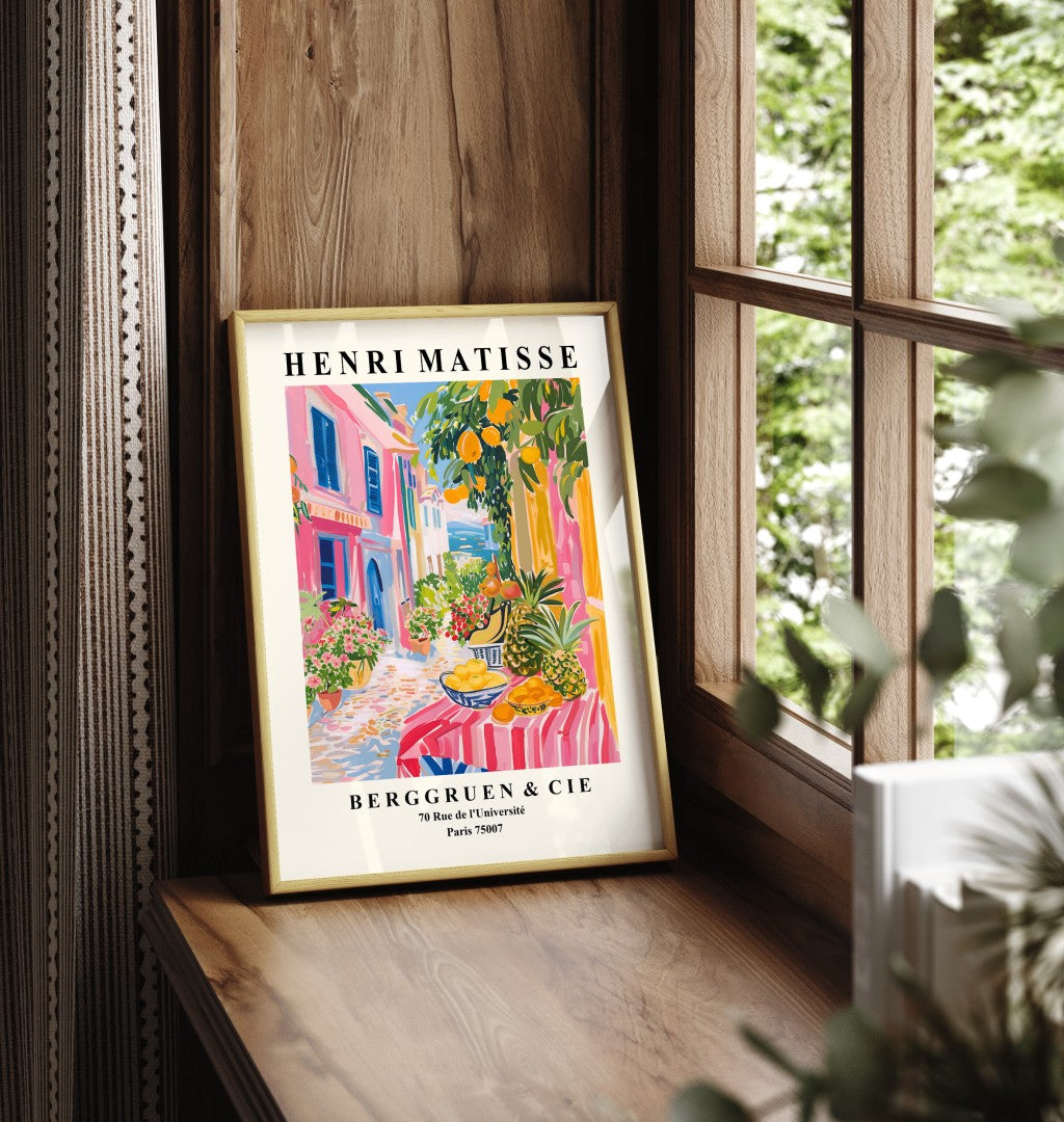 Framed art print showing fruit stand with pineapples, oranges, and bananas in coastal street