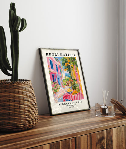 Framed seaside art print of Mediterranean street with fruit stall and bold Matisse colors