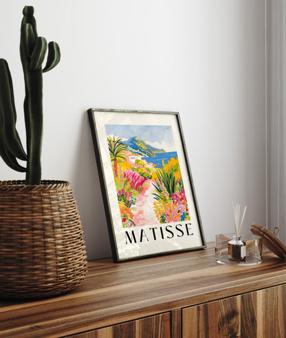Framed coastal art print featuring tropical flowers, sea, and cliffs in bold Matisse style
