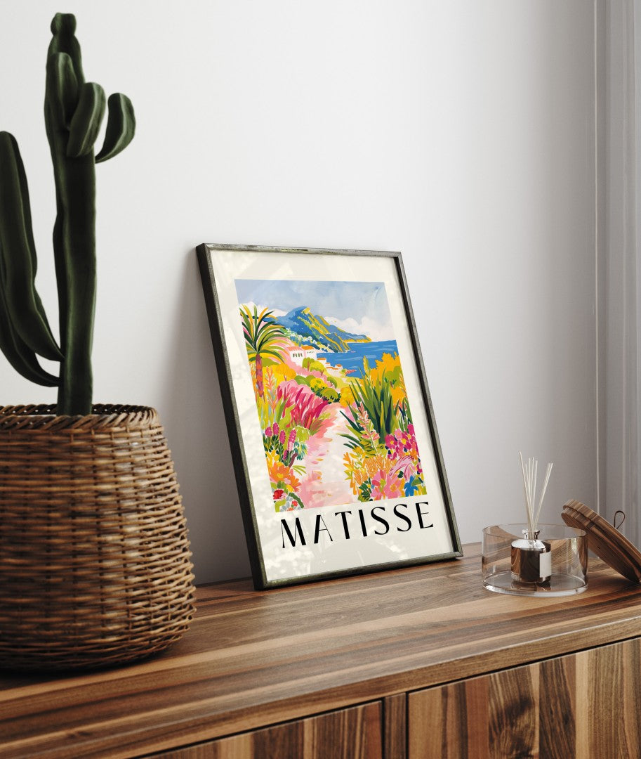 Framed coastal art print featuring tropical flowers, sea, and cliffs in bold Matisse style