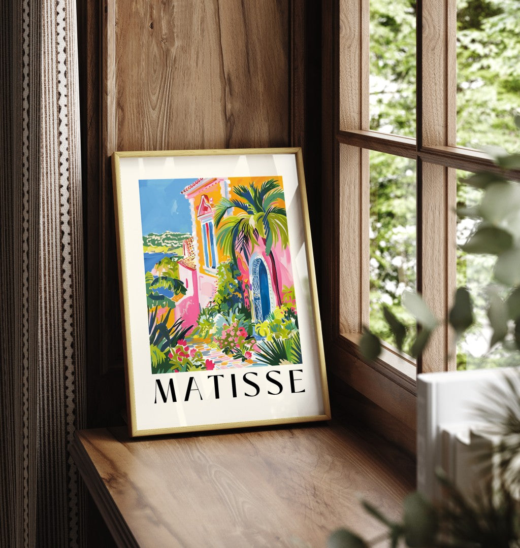 Framed art print showing villa with blue arched door and tropical plants