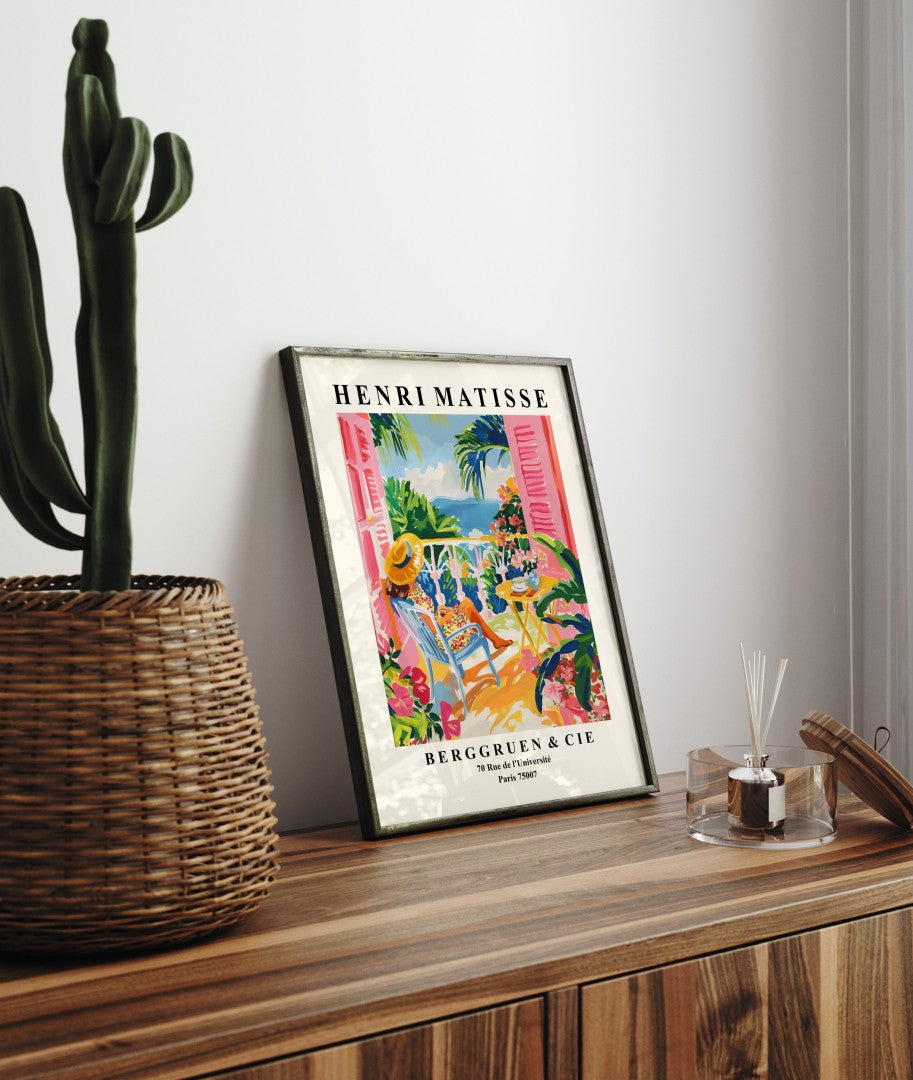 Framed coastal art print of woman relaxing on terrace overlooking ocean in Matisse style