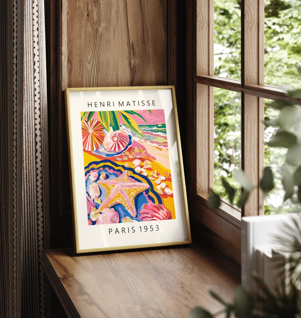 Framed art print showing starfish and shells on golden sandy beach