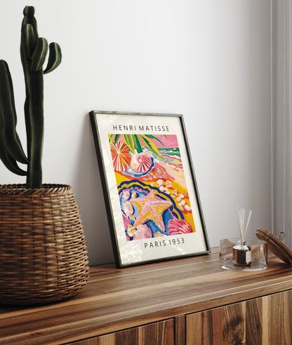 Framed coastal art print featuring starfish, shells, and tropical shoreline in Matisse style