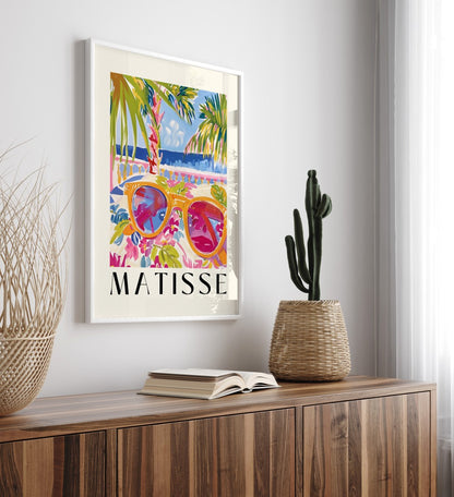 Coastal framed art print featuring golden sunglasses, flowers, and seaside view