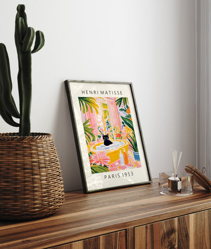 Matisse-style framed artwork of a cat relaxing in a vivid, plant-filled bathroom.