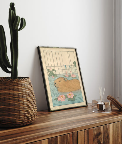Framed bathroom print featuring a content capybara in water with floral accents and serene tones